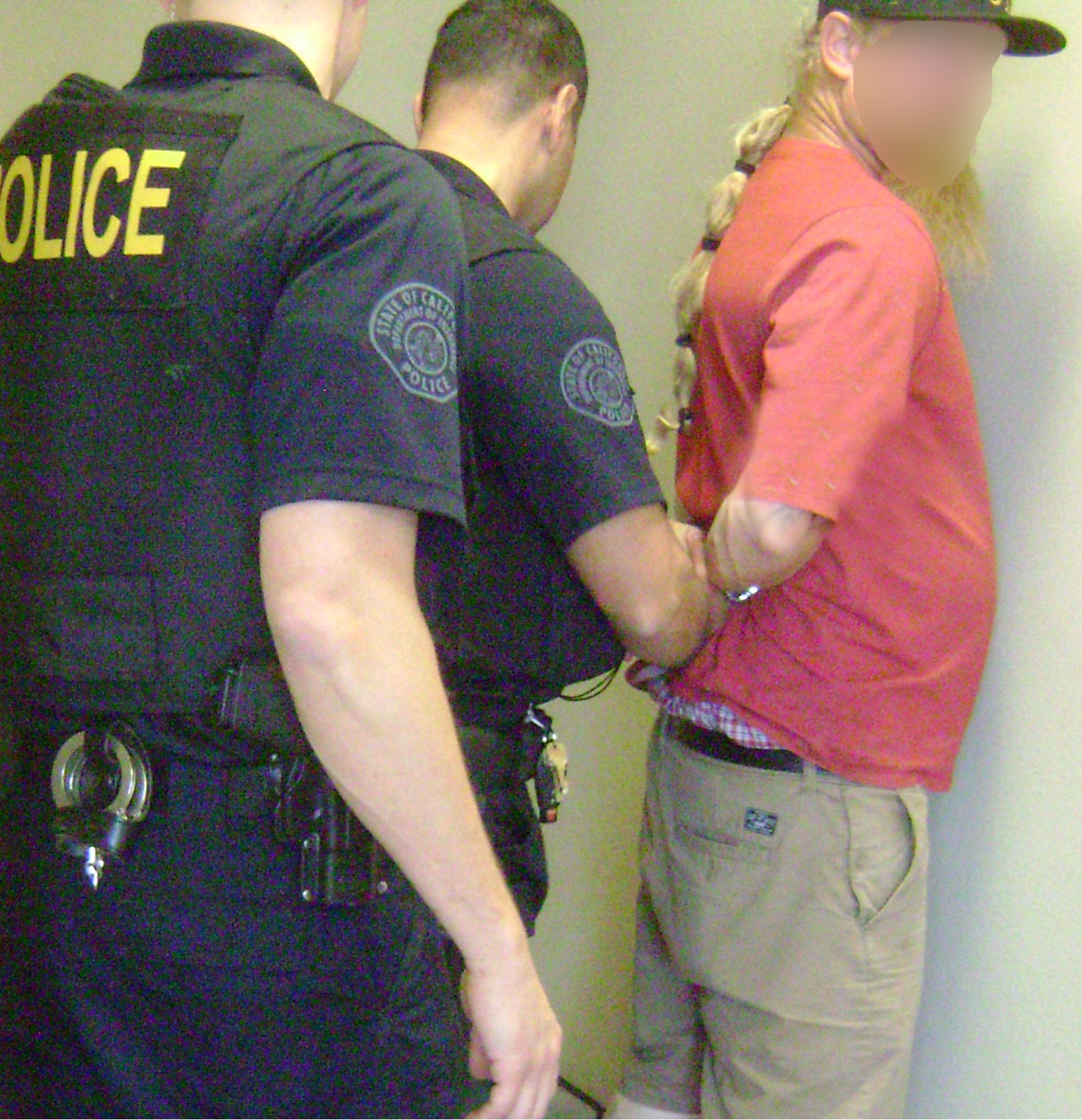 Local law enforcement detaining a suspect to protect SWIFT investigators during the citation process